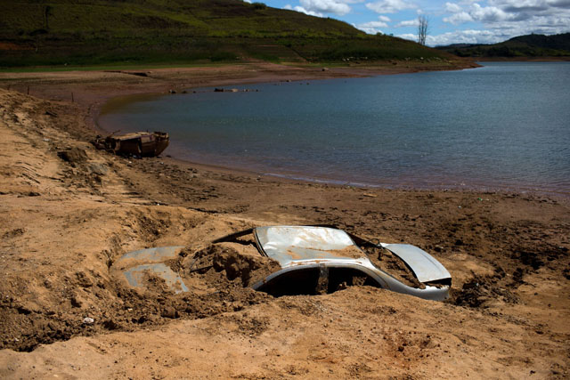 Cars suspected to be stolen and dumped in Jaguari lake appear on dry ground during a prolonged drought in Braganca Paulista