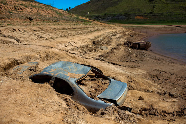 Cars suspected to be stolen and dumped in Jaguari lake appear on dry ground during a prolonged drought in Braganca Paulista