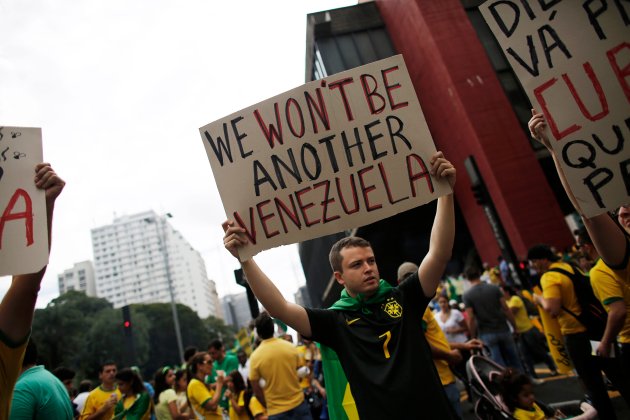 Demonstrator holds a placard during a protest against Brazil's President Dilma Rousseff at Paulista Avenue in Sao Paulo