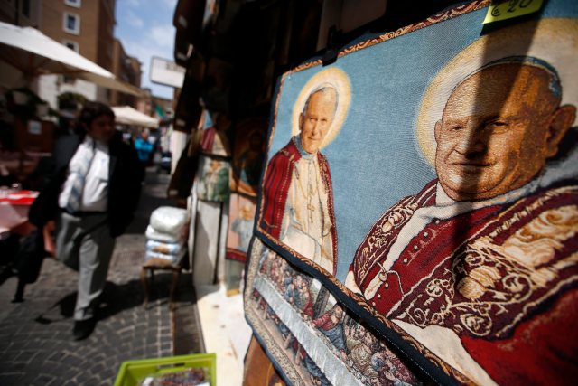 A tapestry depicting Pope John XXIII and Pope John Paul II is displayed in a shop in Rome