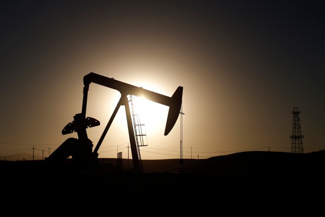 An oil derrick is seen at sunrise near Bakersfield