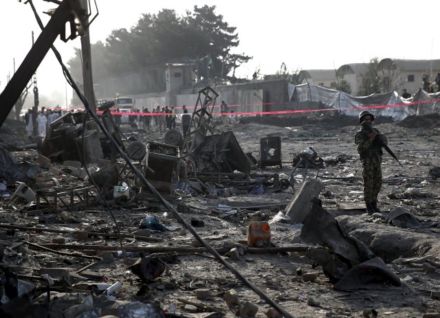 An Afghan National Army soldier keeps watch at the site of a truck bomb attack in Kabul, Afghanistan