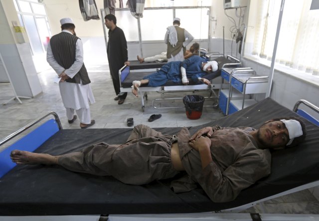 Afghan men receive treatment at a hospital after a suicide truck bomb attack in Kabul, Afghanistan