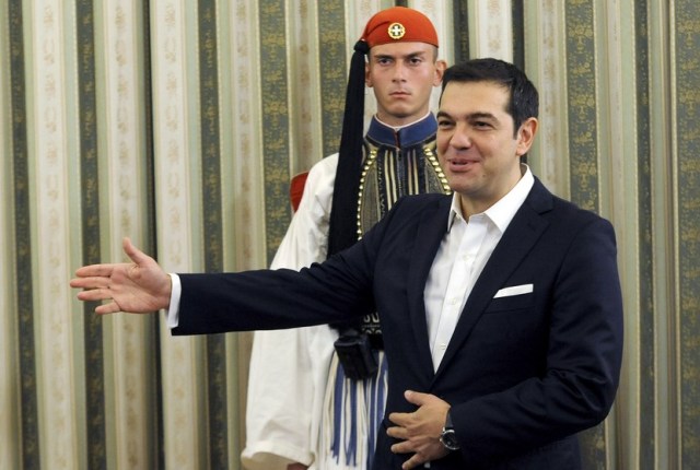 Newly appointed Greek Prime Minister Alexis Tsipras gestures during a swearing-in ceremony at the presidential palace in Athens, Greece, September 23, 2015. Greece's new cabinet was sworn in on Wednesday, bringing in few new faces as re-elected Prime Minister Tspiras sought continuity in pushing through economic reforms under the watchful eye of international lenders. REUTERS/Michalis Karagiannis