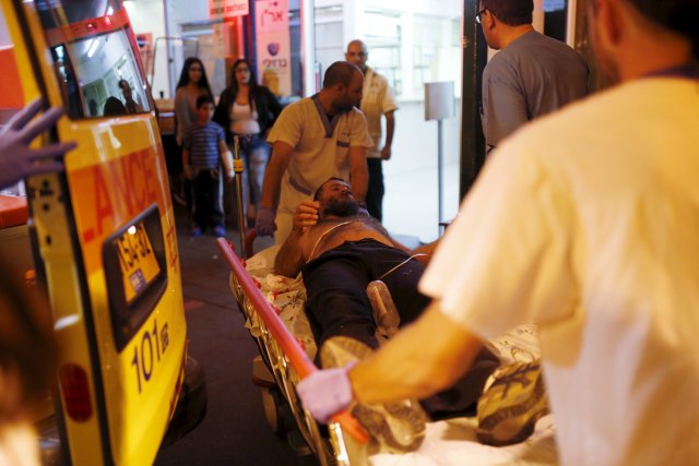 Israeli medics evacuate a man wounded in what Israeli police suspect might be a Palestinian stabbing attack, to Barzilai hospital in the southern city of Ashkelon, Israel November 21, 2015. REUTERS/Amir Cohen