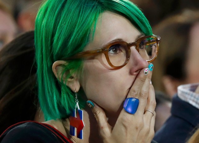 A supporter of U.S. Democratic presidential nominee Hillary Clinton watches results at her election night rally in Manhattan, New York, U.S., November 8, 2016. REUTERS/Lucas Jackson