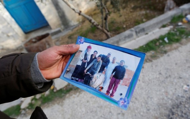 Brother of the Berlin Christmas market truck attack suspect Anis Amri, shows a picture of Anis Amri (C), in Oueslatia, Tunisia December 23, 2016. REUTERS/Zoubeir Souissi