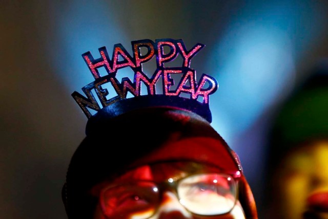 A woman waits for the New Year celebrations for 2017 in Cologne, Germany, December 31, 2016. REUTERS/Wolfgang Rattay