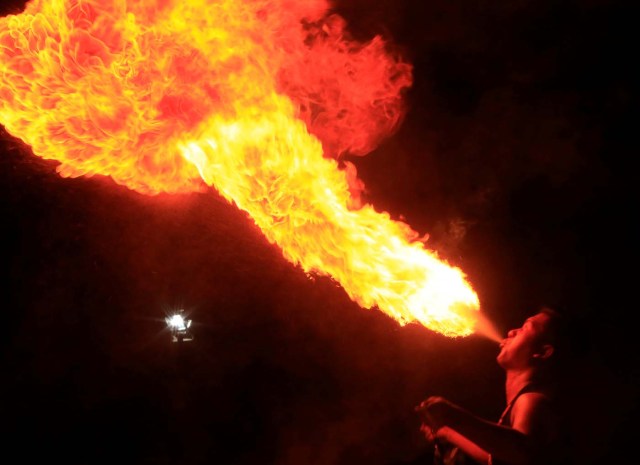 Alan Boi, a fire dancer, performs during New Year celebrations in Luneta park, metro Manila, Philippines December 31, 2016. REUTERS/Romeo Ranoco