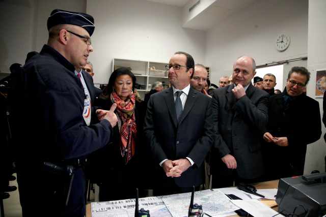 France's President Francois Hollande (C) and Interior Minister Bruno Le Roux (2ndR) visit the security measures at the Champs Elysees Avenue in Paris, France, December 31, 2016. REUTERS/Thibault Camus/ Pool