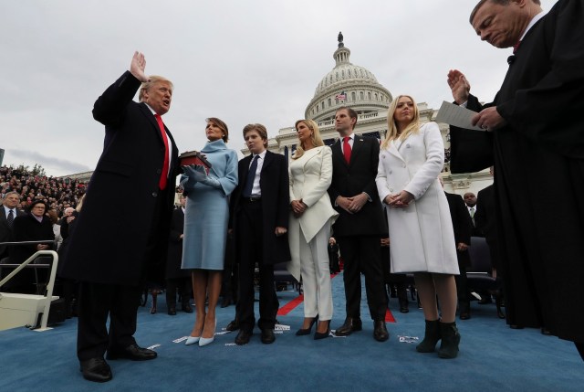 US President Donald Trump takes the oath of office as his wife Melania holds the bible and his children Barron, Ivanka, Eric and Tiffany watch as US Supreme Court Chief Justice John Roberts (R) administers the oath during inauguration ceremonies swearing in Trump as the 45th president of the United States on the West front of the US Capitol in Washington, DC, January 20, 2017. Donald Trump was sworn in as the 45th president of the United States Friday -- ushering in a new political era that has been cheered and feared in equal measure. / AFP PHOTO / POOL / JIM BOURG