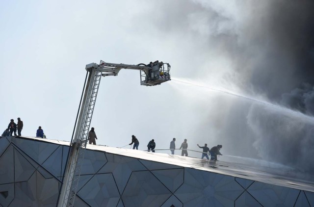 Firefighters work to contain a fire at Jaber Al Ahmad Cultural Centre in Kuwait City, Kuwait February 6, 2017. REUTERS/Stephanie McGehee
