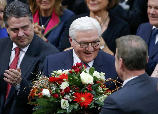 German president-elect, Frank-Walter Steinmeier, receives flowers after the first round of voting of the German presidential election at the Reichstag in Berlin, February 12, 2017. REUTERS/Hannibal Hanschke