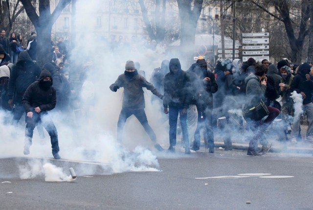 Clouds of tear gas surround youths as they face off with French police during a demonstration against police brutality after a young black man, 22-year-old youth worker named Theo, was severely injured during his arrest earlier this month, in Paris, France, February 23, 2017. REUTERS/Gonzalo Fuentes