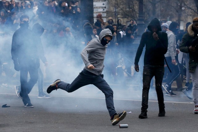 Clouds of tear gas surround youths as they face off with French police during a demonstration against police brutality after a young black man, 22-year-old youth worker named Theo, was severely injured during his arrest earlier this month, in Paris, France, February 23, 2017. REUTERS/Gonzalo Fuentes