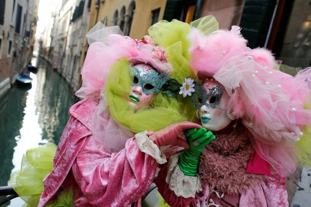 Masked revellers pose during the Venice Carnival in Venice, Italy February 12, 2017. REUTERS/Tony Gentile