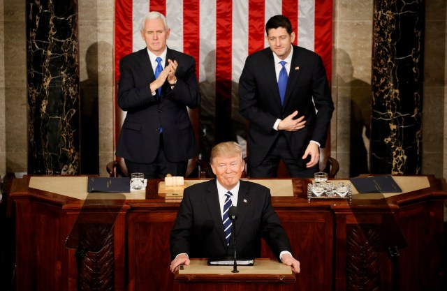 U.S. President Trump addresses Joint Session of Congress - Washington, U.S. - 28/02/17 - U.S. President Donald Trump pauses as he speaks in front of Vice President Mike Pence (L) and Speaker of the House Paul Ryan. REUTERS/Jim Bourg TPX IMAGES OF THE DAY