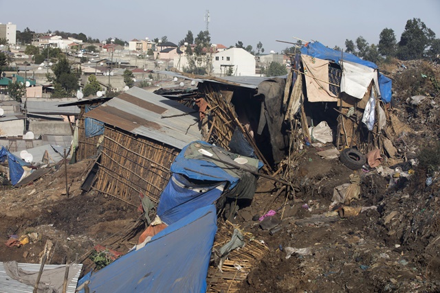 A photo taken on March 12, 2017 shows damaged dwellings after a landslide in the main city dump of Addis Ababa left at least 30 people dead. At least 30 people died and dozens more were hurt in a giant landslide at Ethiopia's largest rubbish dump outside Addis Ababa, a tragedy squatters living there blamed on a biogas plant being built nearby. The landslide saw dozens of homes of people living in the dump levelled after a part of the largest pile of rubbish at the Koshe landfill collapsed, an AFP journalist said. / AFP PHOTO / ZACHARIAS ABUBEKER