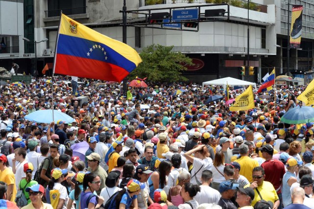 Demonstrators against Nicolas Maduro's government gather at Chacao municipality, east of Caracas on April 8, 2017. The opposition is accusing pro-Maduro Supreme Court judges of attempting an internal "coup d'etat" for attempting to take over the opposition-majority legislature's powers last week. The socialist president's supporters held counter-demonstrations on Thursday, condemning Maduro's opponents as "imperialists" plotting with the United States to oust him. / AFP PHOTO / FEDERICO PARRA