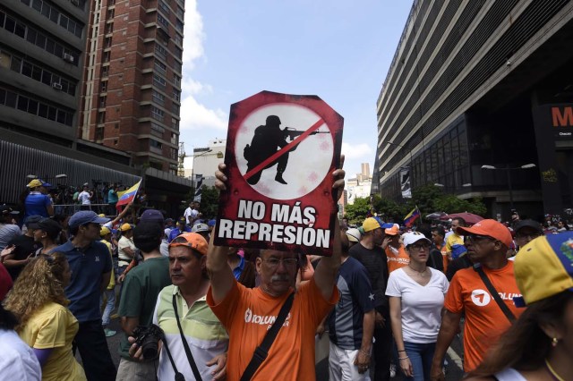 Demonstrators against Nicolas Maduro's government gather at Chacao municipality, east of Caracas on April 8, 2017. The opposition is accusing pro-Maduro Supreme Court judges of attempting an internal "coup d'etat" for attempting to take over the opposition-majority legislature's powers last week. The socialist president's supporters held counter-demonstrations on Thursday, condemning Maduro's opponents as "imperialists" plotting with the United States to oust him. / AFP PHOTO / JUAN BARRETO