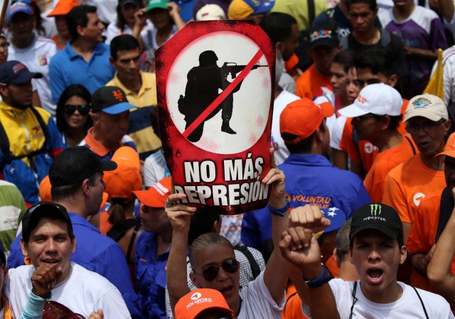 People participate in an opposition rally in Caracas, Venezuela, April 8, 2017. The sign reads "no more repression". REUTERS/Carlos Garcia Rawlins