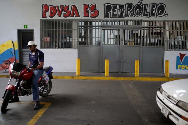 A graffiti that reads "PDVSA is oil" is seen at a gas station in Caracas, Venezuela April 12, 2017. Picture taken April 12, 2017. REUTERS/Marco Bello