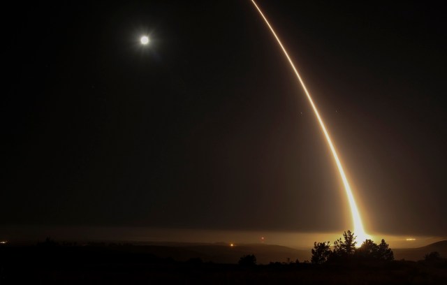 A streak of light trails off into the night sky as the US military test fires an unarmed intercontinental ballistic missile (ICBM) at Vandenberg Air Force Base, some 130 miles (209 kms) northwest of Los Angeles, California early on May 3, 2017. / AFP PHOTO / RINGO CHIU