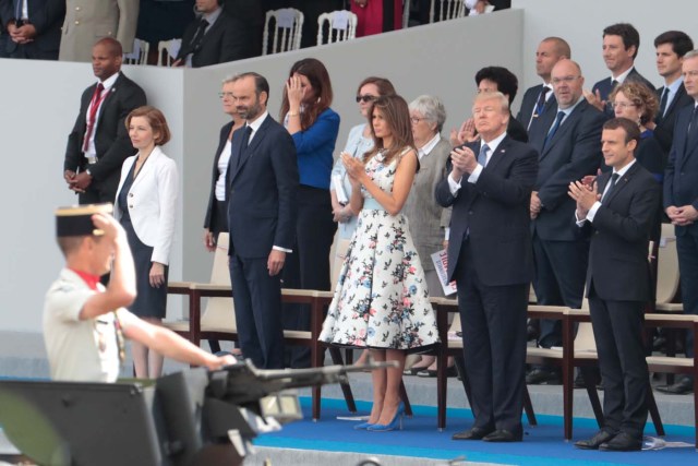 (Bottom row, from R) French President Emmanuel Macron, US President Donald Trump, US First Lady Melania Trump, French Prime Minister Edouard Philippe and French Defence Minister Florence Parly attend the annual Bastille Day military parade on the Champs-Elysees avenue in Paris on July 14, 2017. The parade on Paris's Champs-Elysees will commemorate the centenary of the US entering WWI and will feature horses, helicopters, planes and troops. / AFP PHOTO / joel SAGET