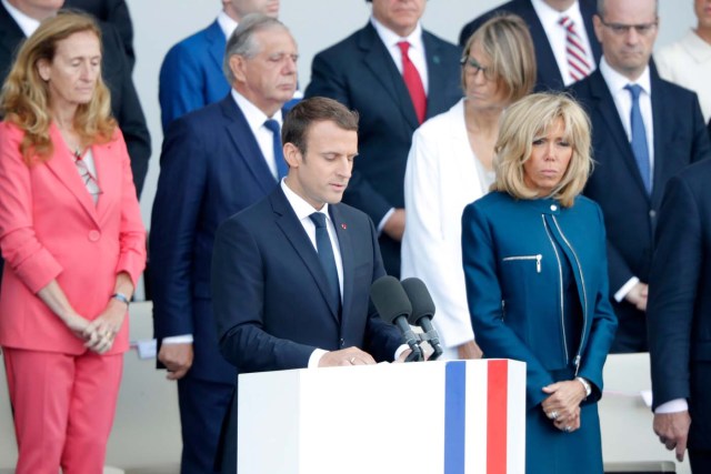 French President Emmanuel Macron delivers a speech next to his wife Brigitte Macron at the end of the traditional Bastille Day military parade on the Champs-Elysees in Paris, France, July 14, 2017. REUTERS/Charles Platiau