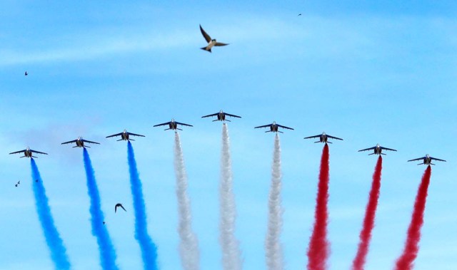 Alpha jets from the French Air Force Patrouille de France fly over Paris during the traditional Bastille Day military parade, France, July 14, 2017. REUTERS/Philippe Wojazer