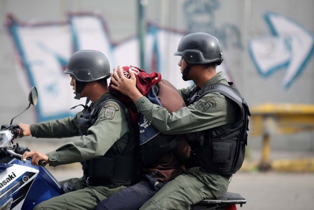 A demonstrator is detained at a rally during a strike called to protest against Venezuelan President Nicolas Maduro's government in Caracas, Venezuela July 27, 2017 . REUTERS/Ueslei Marcelino