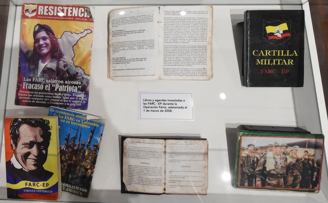 Books belonging to members of Revolutionary Armed Forces of Colombia (FARC) seized by the Colombian army during the Fenix operation March 1, 2008, are on displayn during the opening of Colombia's General Prosecutor's Office museum in Bogota, on July 7, 2017. The museum was inaugurated within the framework of the 25th anniversary of the General Prosecutor's Office and aims to bring to the public to objects seized in judicial processes in the country. / AFP PHOTO / Raul Arboleda