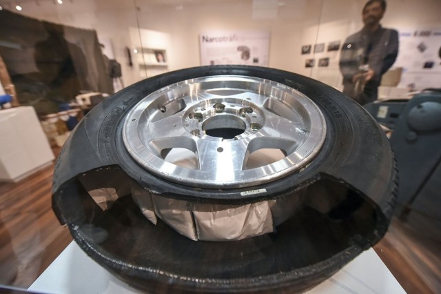 A replica of a tire refilled with narcotis is on displayn during the opening of Colombia's General Prosecutor's Office museum in Bogota, on July 7, 2017. The museum was inaugurated within the framework of the 25th anniversary of the General Prosecutor's Office and aims to bring to the public to objects seized in judicial processes in the country. / AFP PHOTO / Raul Arboleda