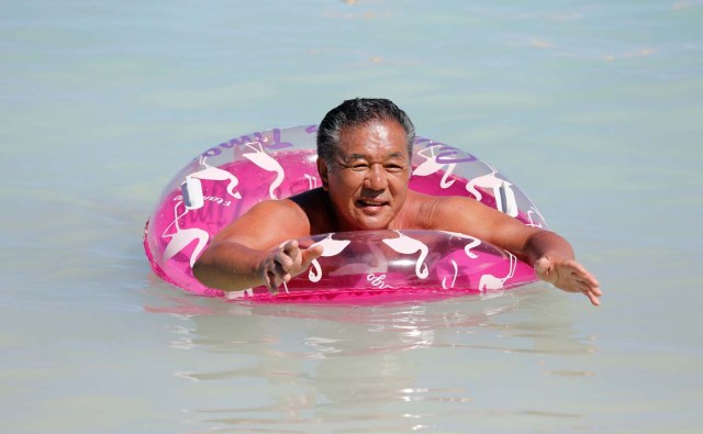 A tourist enjoys the waters off the Tumon Beach on the island of Guam, a U.S. Pacific Territory, August 12, 2017. REUTERS/Erik De Castro