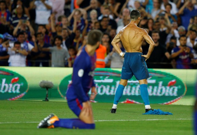 Soccer Football - Barcelona v Real Madrid Spanish Super Cup First Leg - Barcelona, Spain - August 13, 2017   Real Madrid’s Cristiano Ronaldo celebrates scoring their second goal and is later booked for removing his shirt   REUTERS/Juan Medina