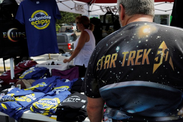 A man wearing a Star Trek t-shirt shops for commemorative eclipse t-shirts in Carbondale, Illinois, U.S., August 20, 2017, one day before the total solar eclipse. REUTERS/Brian Snyder NO RESALES. NO ARCHIVES.