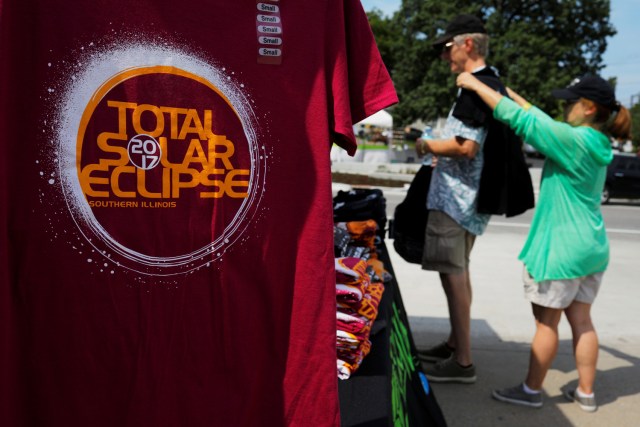 People shop for commemorative t-shirts in Carbondale, Illinois, U.S., August 20, 2017, one day before the total solar eclipse. REUTERS/Brian Snyder NO RESALES. NO ARCHIVES