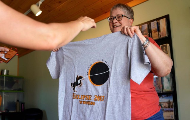 Sue Martindale displays an eclipse t-shirt for sale in Guernsey, Wyoming U.S. August 20, 2017. REUTERS/Rick Wilking NO RESALES. NO ARCHIVES.
