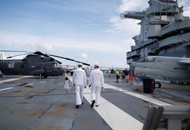 Sailors walk on the flight deck of the Naval museum ship U.S.S. Yorktown before festivities start for the Great American Eclipse in Mount Pleasant, South Carolina, U.S. August 21, 2017. Location coordinates for this image are 32°47'26" N 79°54'31" W. REUTERS/Randall Hill
