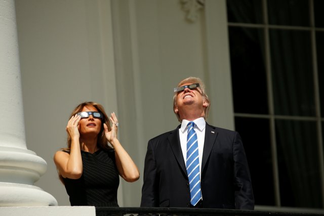 U.S. President Donald Trump watches the solar eclipse with first Lady Melania Trump from the Truman Balcony at the White House in Washington, U.S., August 21, 2017. REUTERS/Kevin Lamarque