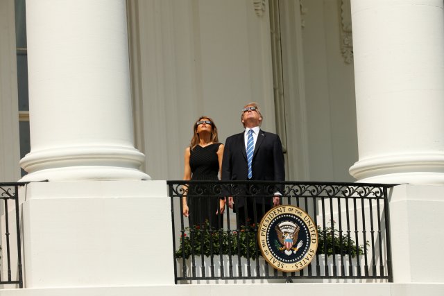 U.S. President Donald Trump watches the solar eclipse with first Lady Melania Trump from the Truman Balcony at the White House in Washington, U.S., August 21, 2017. REUTERS/Kevin Lamarque