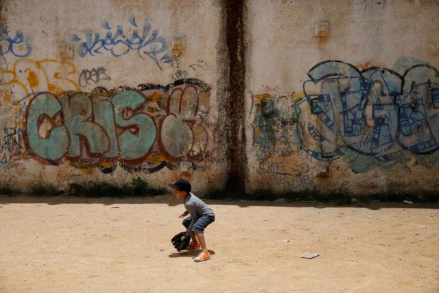 Aiberth Tovar, 7, practices baseball close his house in Caracas, Venezuela August 30, 2017. Picture taken August 30, 2017. REUTERS/Carlos Garcia Rawlins