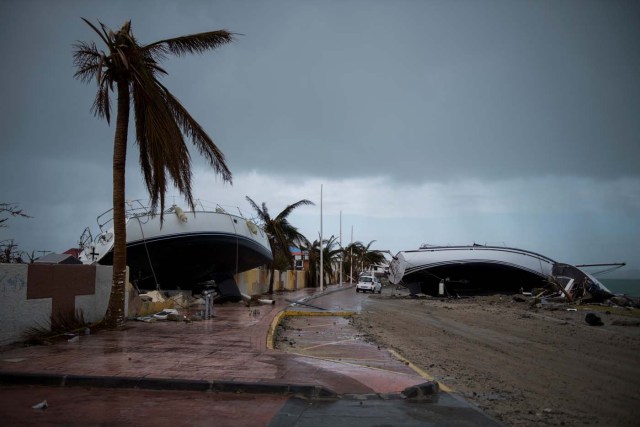 Two sailing boats are beached on a road of Marigot, on September 9, 2017 in Saint-Martin island devastated by Irma hurricane. Officials on the island of Guadeloupe, where French aid efforts are being coordinated, suspended boat crossings to the hardest-hit territories of St. Martin and St. Barts where 11 people have died. Two days after Hurricane Irma swept over the eastern Caribbean, killing at least 17 people and devastating thousands of homes, some islands braced for a second battering from Hurricane Jose this weekend. / AFP PHOTO / Martin BUREAU