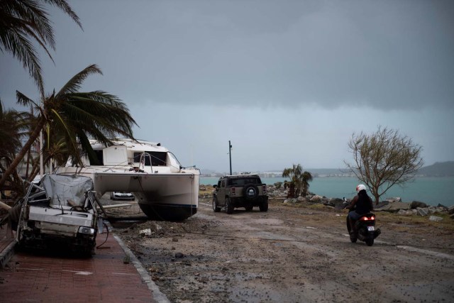 A sailing boat is beached on a road of Marigot, on September 9, 2017 in Saint-Martin island devastated by Irma hurricane. Officials on the island of Guadeloupe, where French aid efforts are being coordinated, suspended boat crossings to the hardest-hit territories of St. Martin and St. Barts where 11 people have died. Two days after Hurricane Irma swept over the eastern Caribbean, killing at least 17 people and devastating thousands of homes, some islands braced for a second battering from Hurricane Jose this weekend. / AFP PHOTO / Martin BUREAU