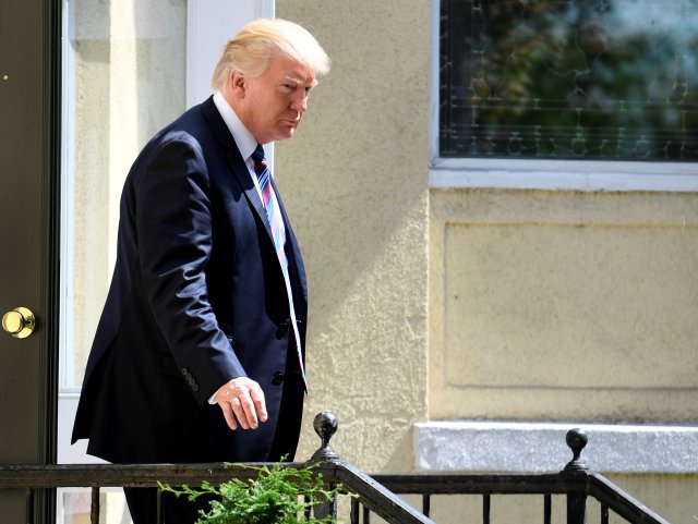 President Donald Trump departs St. John's Episcopal Church ahead of First Lady Melania Trump after they attended services for a national "Day of Prayer", for victims of the Hurricane Harvey flooding in Texas, in Washington, U.S., September 3, 2017.           REUTERS/Mike Theiler