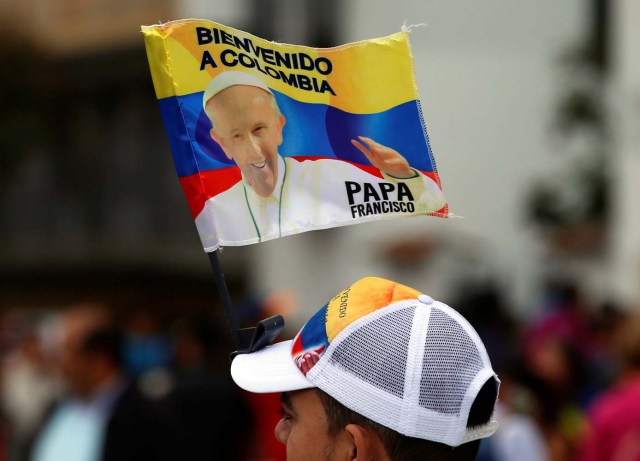 A man sells a banner with an images of Pope Francis outside at the Cathedral of Bogota in Bolivar Square, Colombia September 3, 2017. REUTERS/Henry Romero