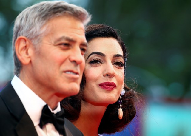 Actor and director George Clooney and his wife Amal pose during a red carpet event for the movie "Suburbicon" at the 74th Venice Film Festival in Venice, Italy September 2, 2017. REUTERS/Alessandro Bianchi