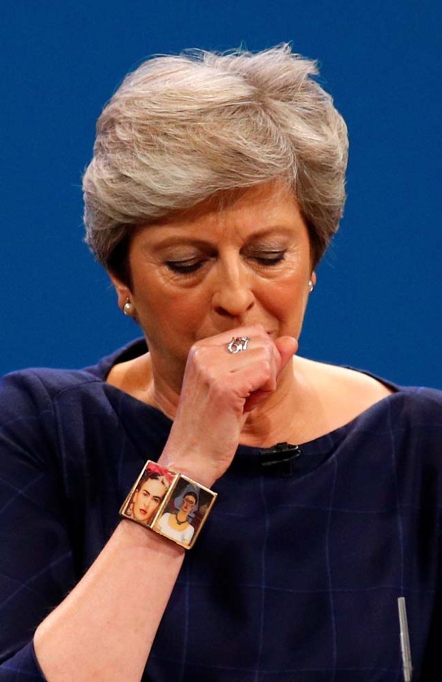 Britain's Prime Minister Theresa May coughs as she addresses the Conservative Party conference in Manchester, October 4, 2017. REUTERS/Phil Noble