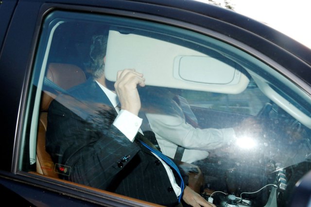 Former Trump campaign manager Paul Manafort, one focus of special counsel Robert Mueller's investigation into alleged Russian meddling in the 2016 U.S. presidential election, hides behind his car visor as he leaves his home in Alexandria, Virginia, U.S. October 30, 2017. REUTERS/Jonathan Ernst TPX IMAGES OF THE DAY