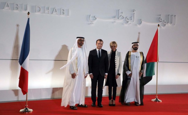 (From L-R) Abu Dhabi Crown Prince Mohammed bin Zayed al-Nahyan, French President Emmanuel Macron, his wife Brigitte Macron and Ruler of Dubai Sheikh Mohammed bin Rashid al-Maktoum pose at the entrance of the Louvre Abu Dhabi Museum during its inauguration in Abu Dhabi, UAE, November 8, 2017. Picture taken November 8, 2017. REUTERS/Ludovic Marin/Pool